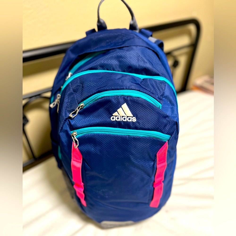 Multi pocketed Adidas utility backpack, great for school or camping.
